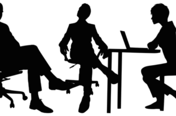 A group of professionals conducting an interview in a modern office setting, with one candidate being interviewed by a panel of interviewers. The image conveys a formal and professional atmosphere, highlighting the interview process at Concentric Advisors.
